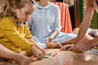 © Milles Studio/Stocksy - Crop parents with girl on floor playing