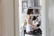© Bowery Image Group Inc./Stocksy - A woman standing in her kitchen