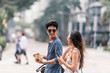 © Santi Nunez/Stocksy - Smiling couple chatting and having fun in the street