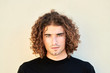 © guille Faingold/Stocksy - Handsome man with curly hair.