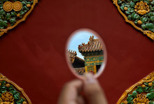 Children Look At Ancient Buildings With Mirrors. In China
