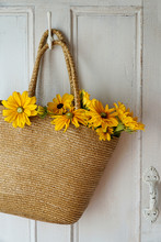 Closeup Of Straw Purse With Flowers On Door Hook