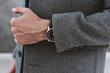 © Lyuba Burakova/Stocksy - Man wearing grey wool coat and watch