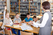 © JackF - Female librarian and schoolkids during classes in library