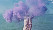 © Lyuba Burakova/Stocksy - Man holding smoke bomb