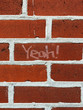 © Jen Grantham Photography/Stocksy - Yeah!'' written on a brick wall