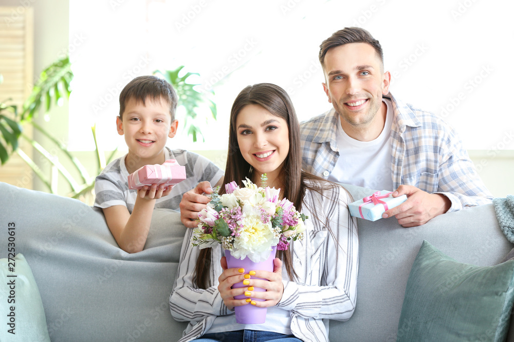 Family greeting young woman at home