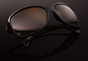 Sunglasses on a dark background, close up