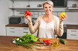 © Pixel-Shot - Mature woman cooking in kitchen