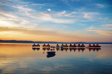 Wall Mural - Lake Balaton at sunset with pedalos and pedal boats at Balaontlelle, Hungary