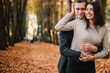 © zadorozhna - Beautiful young couple hugging in autumn park.