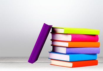 Colorful books stack collection on white desk