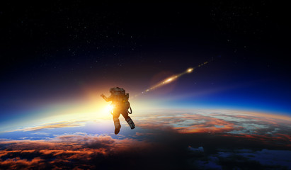 Wall Mural - astronaut in space on planet orbit.