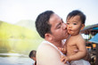 © AlivePhoto - Asian man carrying his adorable daughter, Dad kissing baby girl