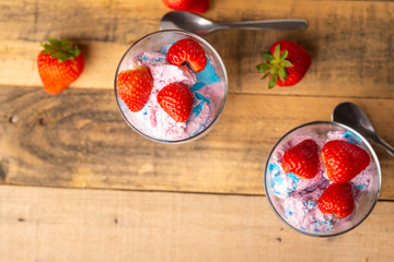 Wall Mural - Ice cream with strawberries on wooden background.Flat lay.Summer mood