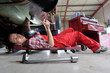 female mechanic underneath a car