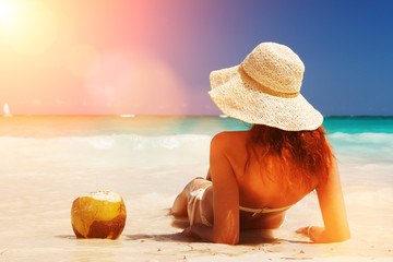 Wall Mural - Young fashion woman relax on the beach. Happy island lifestyle. White sand, blue cloudy sky and crystal sea of tropical beach. Vacation at Paradise. Ocean beach relax, travel to desert islands