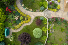 Garden With Walkways And Green Grass. Photo Taken From Above Drone.