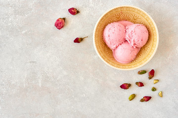 Poster - Strawberry rosewater ice cream , frozen yogurt with pistachio and rosebud. Top view with copy space	