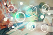© peshkova - Media network theme hologram with man working on computer on background. Concept of internet communication. Double exposure.