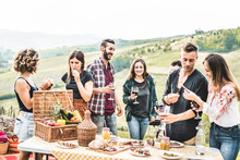 Happy Adult Friends Eating At Picnic Lunch In Italian Vineyard Outdoor - Young People Having Fun On Gastronomic Weekend Tuscany Tour - Friendship, Summer And Food Concept - Focus On Center Guys