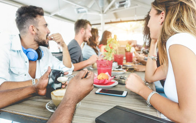 Wall Mural - Group of happy friends drinking coffee and cappuccino at vintage bar - Young students people eating and talking at breakfast - Friendship, trend and food concept - Focus on indian close-up hand