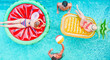 Happy friends playing with air lilo ball inside swimming pool - Young people having fun on summer holidays vacation - Travel, generation trends youth lifestyle, friendship and tropical concept