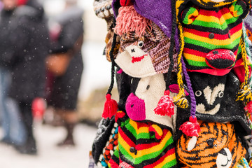 Winter hats on display on a snowy day in holiday city fare. Chri