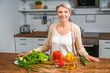 © Pixel-Shot - Mature woman cooking in kitchen