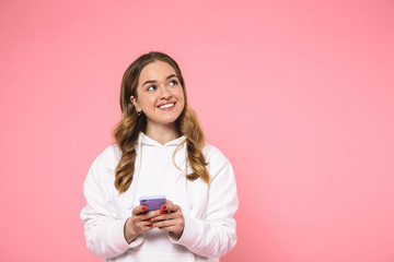 Sticker - Smiling blonde woman wearing in casual clothes holding smartphone