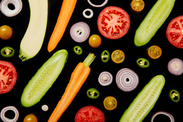 Poster - top view of fresh ripe sliced vegetables isolated on black