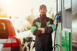 © kegfire - Confident worker refueling car