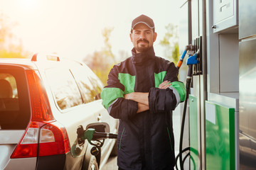 Confident worker refueling car