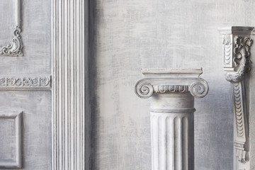 Stone column on light gray background. Close-up, copy space, front view
