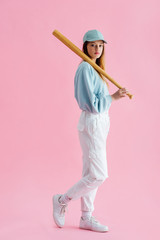 Wall Mural - pretty teenage girl in cap holding baseball bat on pink