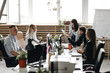 © Leika production - Staff meeting of a young successful team in the light modern office equipped with modern office equipment