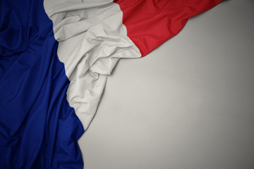 waving national flag of france on a gray background.