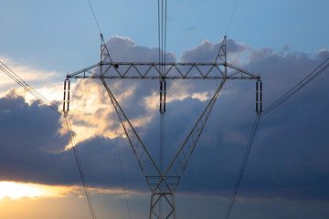 High voltage power lines wit dramatic evening sky