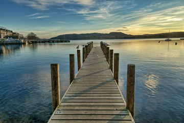  A view of a jetty on Windermere at sunset.