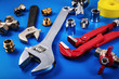 © ronstik - plumbing tools and fittings on blue background