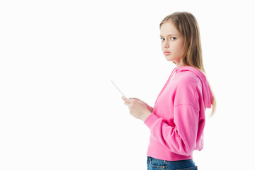 Wall Mural - side view of sad teenage girl using digital tablet isolated on white