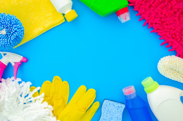 Top view frame mockup cleaning supplies isolated on blue background. Flat lay with copy space