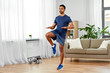 © Syda Productions - sport, fitness and healthy lifestyle concept - indian man running on spot at home