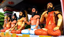 Statues Of Hindu Gods Sitting At Temple 