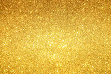 Gold Sparkling Lights Festive Background With Texture. Abstract Christmas Twinkled Bright Bokeh Defocused And Falling Stars. Winter Card Or Invitation