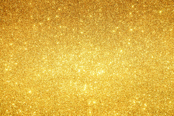 gold sparkling lights festive background with texture. abstract christmas twinkled bright bokeh defo