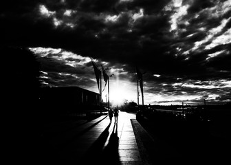 Poster - Street photography with light and shadow. Summer evening on the shore of Vistula river in Warsaw, Poland