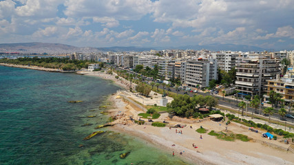 aerial panoramic photo of famous seaside bay of faliro with beautiful emerald sea, clouds and deep b