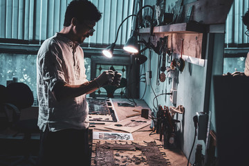 Wall Mural - Diligent craftman is restoring ancient broken stained glass at his own workshop.