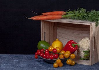 Composition of vegetables on dark cement background. Black background with copy space. Organic food. Organic farming concept. 